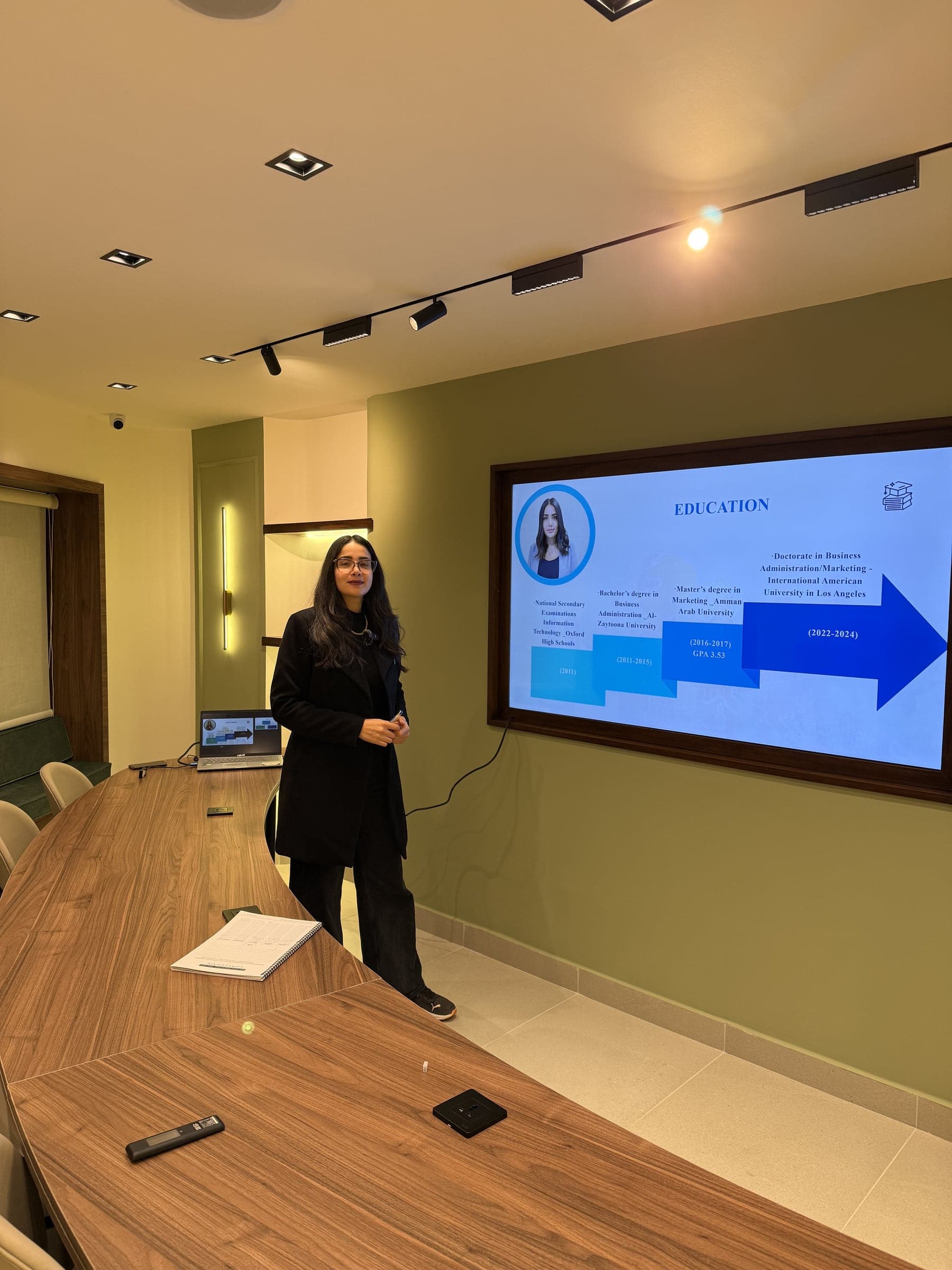 Dr. Shahd presenting to a team in a boardroom