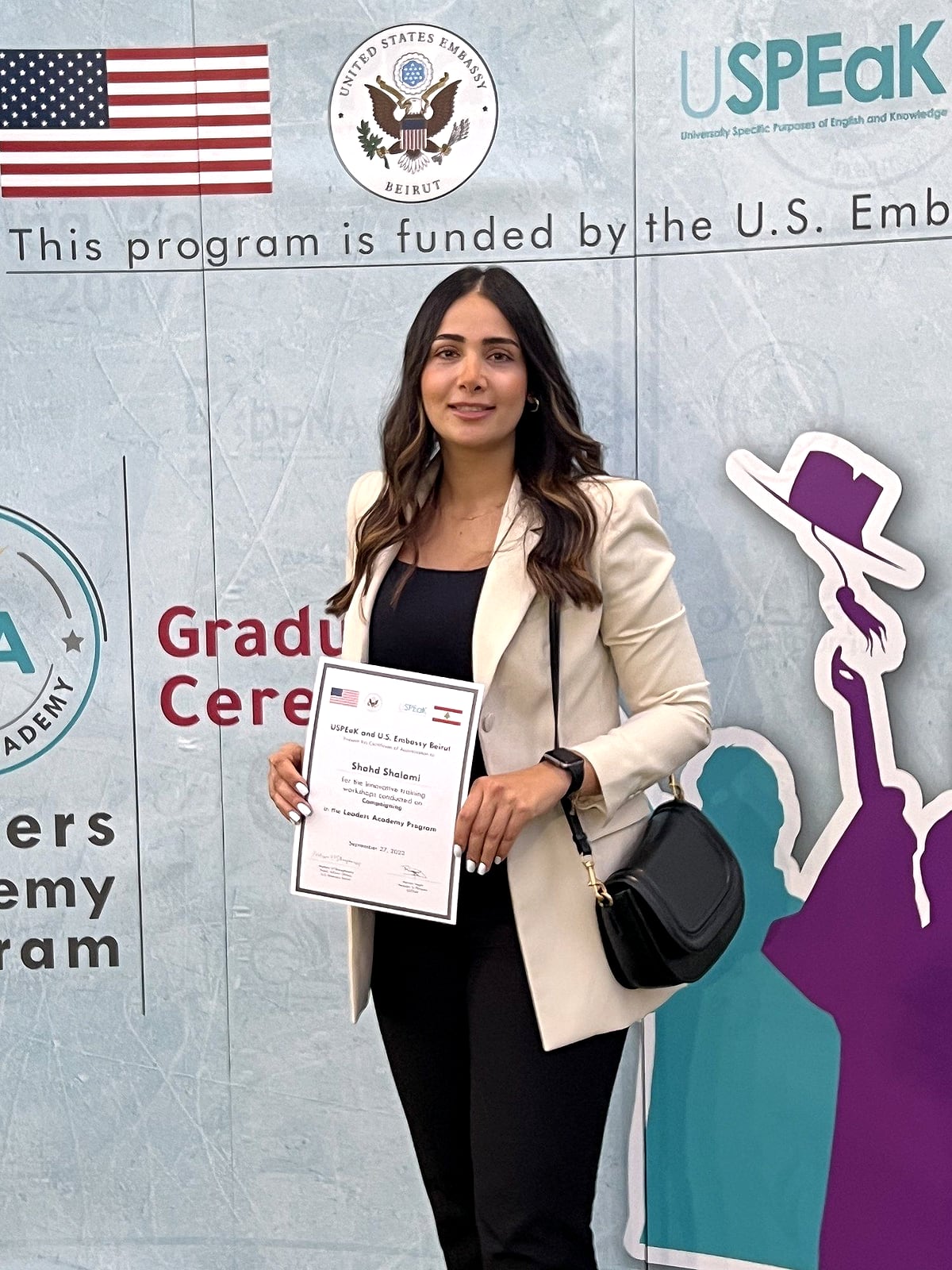 Dr. Shahd Al-Shalami holding her USPEaK certificate